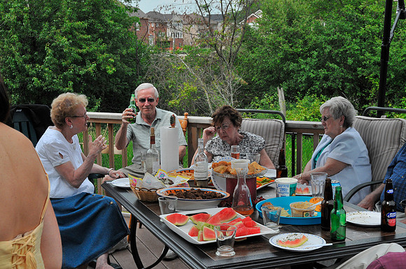 KEN SAYS "CHEERS", WHILE JUNE DRINKS FROM THE INVISIBLE BOTTLE